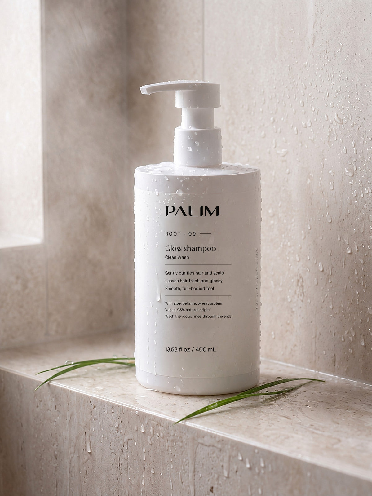 Clean Wash gloss shampoo on a wet stone shower ledge