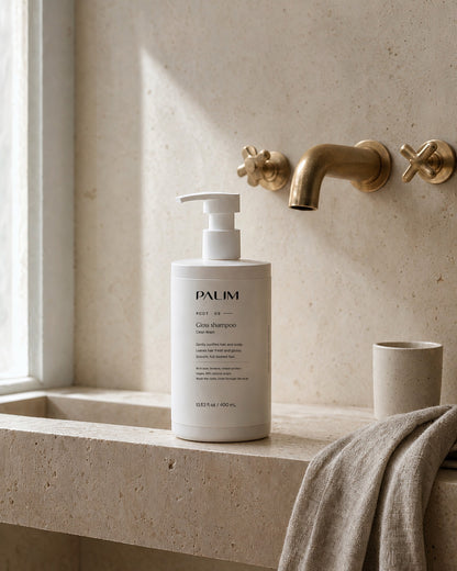 Clean Wash gloss shampoo on a travertine bathroom sink